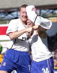 Dean Crowe whips off his shirt after scoring