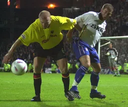 Dean Crowe being held back by Sean Dyche