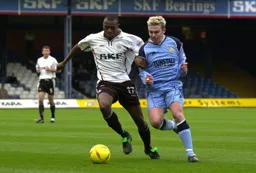 Emmerson Boyce tussles for the ball