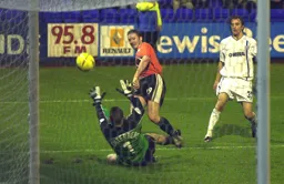 Steve Howard chips the keeper