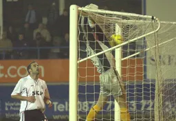 Andrew Fotiadis watches the ball as it lands on the top of the net