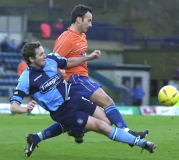 Ahmet Brkovic is tackled by the Wycombe player