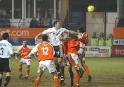 Steve Howard heads the ball strongly