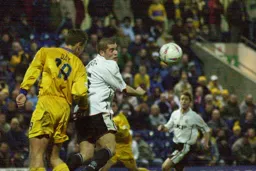 Dean Crowe challenges for a header