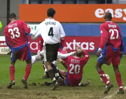 Matthew Spring looks on as Peter Holmes nets