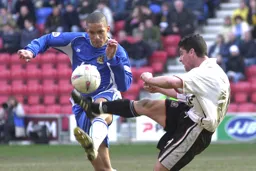 Steve Robinson challenges for the ball