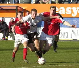 Steve Howard pushes himself through the defenders