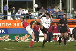 Kevin Nicholls battles it out in midfield