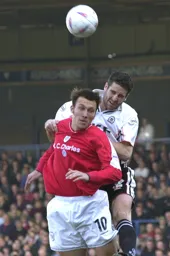 Chris Coyne heads the ball