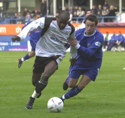 Adrian Forbes on the ball gets his head down