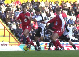 Ahmet Brkovic tries to push Tony Butler out of the way