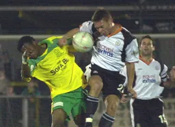 Sol Davis in a heading duel with former Hatter Tresor Kandol
