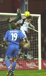 Sasa Ilic knocks the ball away from Steve Howard