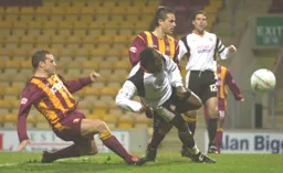 Adrian Forbes scores Town`s second goal with a diving header