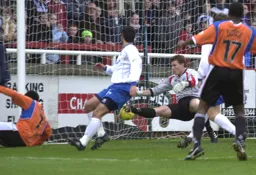 Adrian Forbes slides in at the far post to give Town an early lead