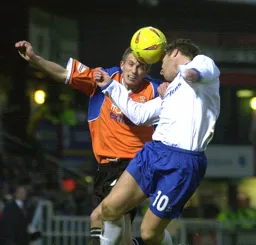 Lee Mansell and Barry Quinn seem to head the ball at the same time