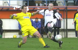 Kevin Nicholls and Micky Mellon compete for the ball