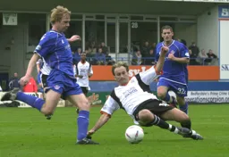 Ahmet Brkovic goes sliding in to tackle Dean Holden