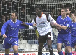 Enoch Showunmi is the victim of some shirt pulling