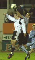 Neil Moss catches the ball under pressure from 1035 Michael Leary