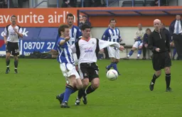 Steve Robinson in a chase for the ball.
