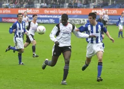 Enoch Showunmi looks to control the ball as Richard Wood moves in to challenge