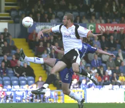 Rowan Vine heads the ball on