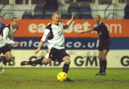 Kevin Nicholls slots home from the spot for goal number three