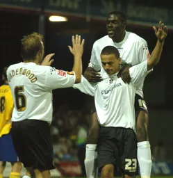 Dean Morgan arms aloft celebrates his goal with Paul Underwood and Enoch Showunmi