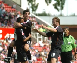 Dean Morgan celebrates his goal with Steven Howard and Stephen Robinson