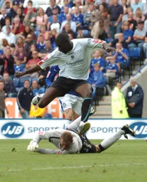 Enoch Showunmi leaps over the Leicester goalkeeper