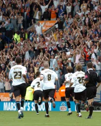 The Luton team run back towards the fans celebrating the second goal