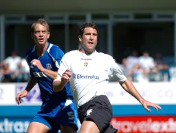 Chris Coyne and Millwall defender compete for the ball