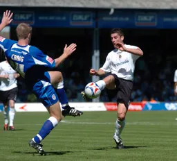 Stephen Robinson controls the ball under pressure from a Millwall player