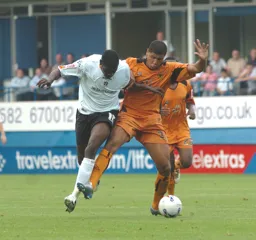 Enoch Showunmi and a Wolves defender challenge for the ball