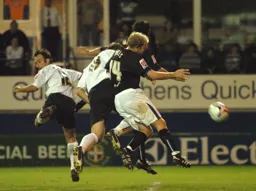 Steven Howard gets between two Sheffield Wednesday defenders to score with a header