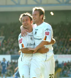 Peter Holmes celebrates his goal with 1019 Ahmet Brkovic