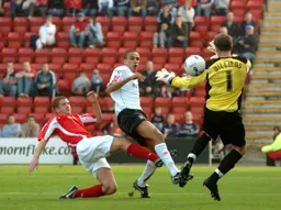 Dean Morgan knocks the ball past the Crewe goalkeeper