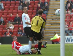 Dean Morgan watches the ball go into the net