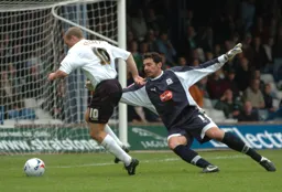 Warren Feeney rounds the goalkeeper