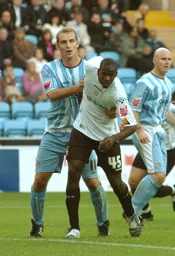 Leon Barnett tussles with a Coventry player