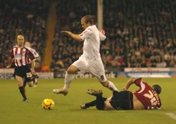 Rowan Vine dribbles past a Sheffield United player on the ground