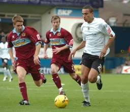 Dean Morgan in control as two Burnley defenders watch on