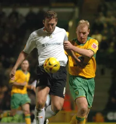 Steven Howard and Gary Doherty tussle for the ball