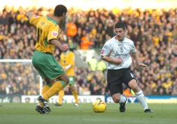 Stephen Robinson takes on a Norwich player