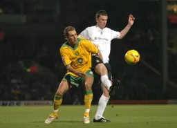 Kevin Foley brings the bal under control challenged by a Norwich player