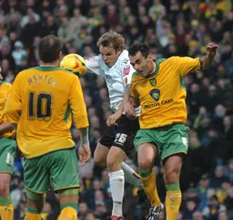 Marcus Heikkinen challenges for a header