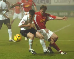 Kevin Foley in a midfield tussle