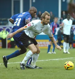 Paul Underwood shields the ball from a Palace player
