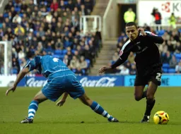 Dean Morgan dribbles past a Reading player
